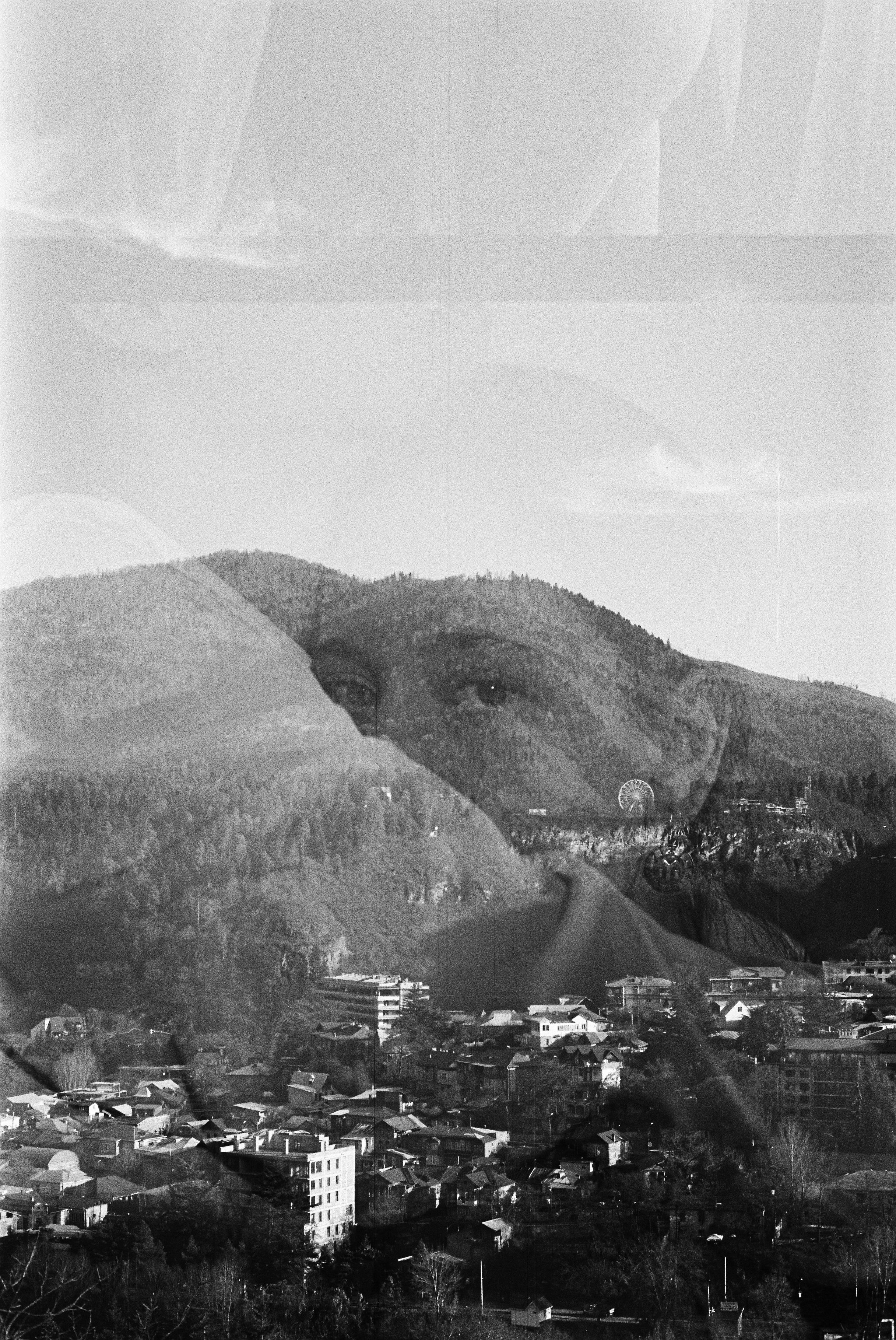 Double-exposure portrait blending a woman's face with a mountain landscape, symbolizing personal growth, identity shifts, and transformation.
